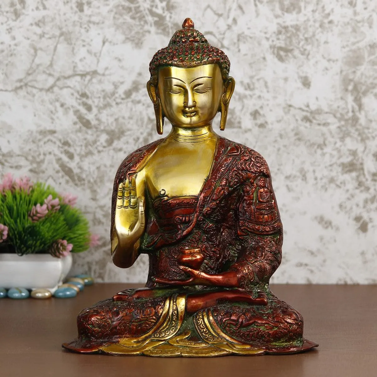 Seated Buddha brass idol with glossy gold face and red textured robe