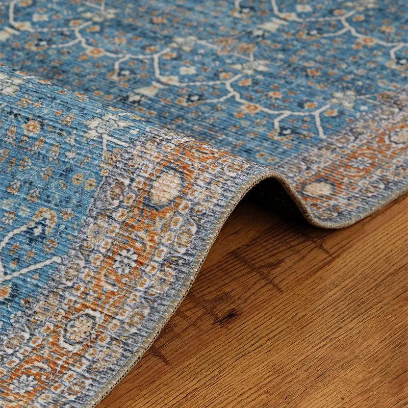 Close-up of blue carpet edge and surface texture on wooden floor