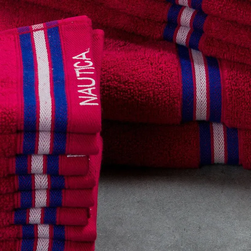 Close-up view of pink towels showing striped borders and soft textured loops.