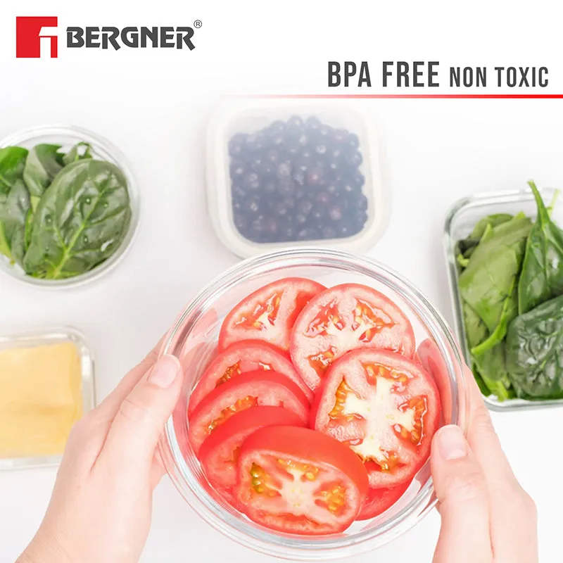 Transparent round glass container filled with sliced tomatoes, shown with fresh ingredients
