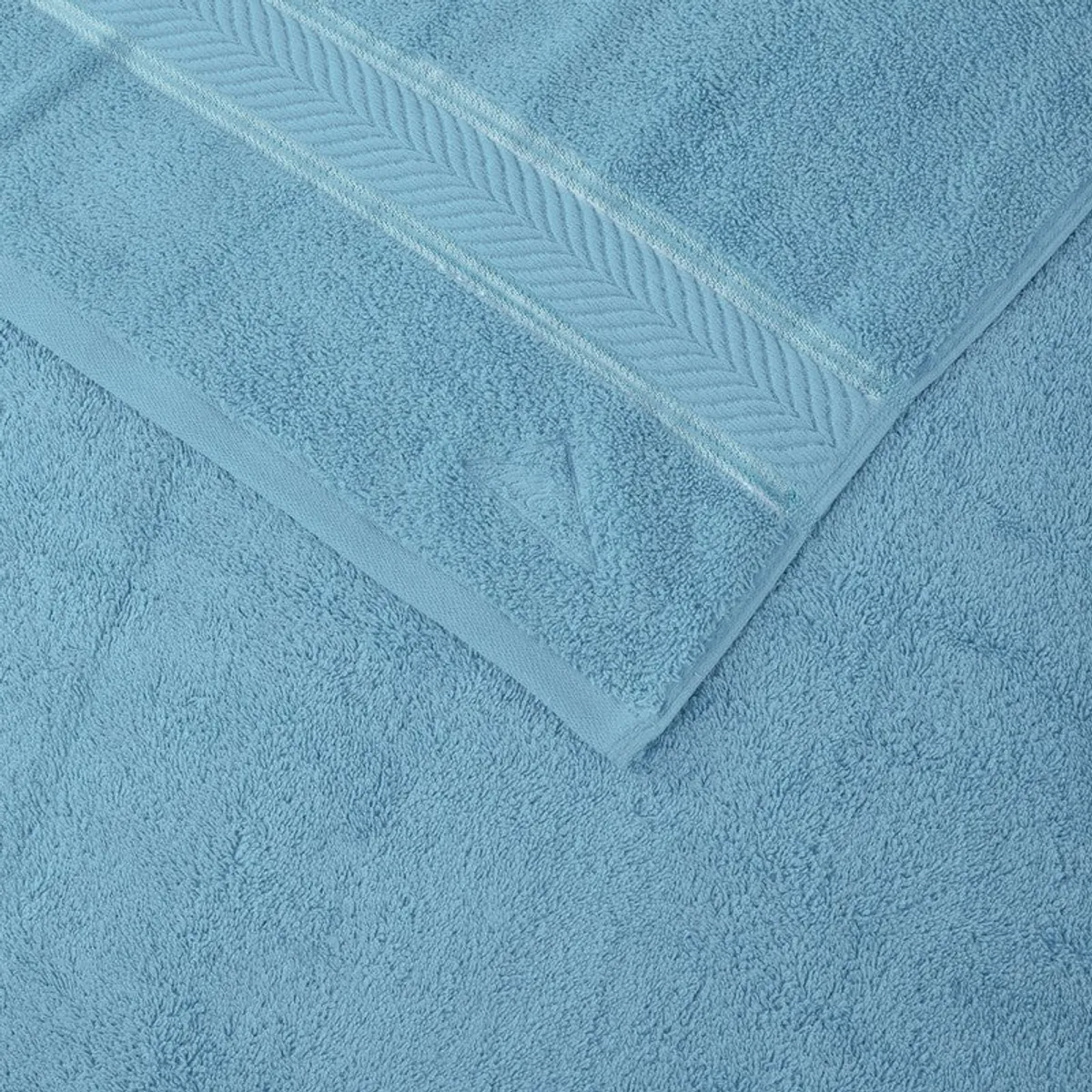 Detailed view of the towel's soft pile and decorative chevron border