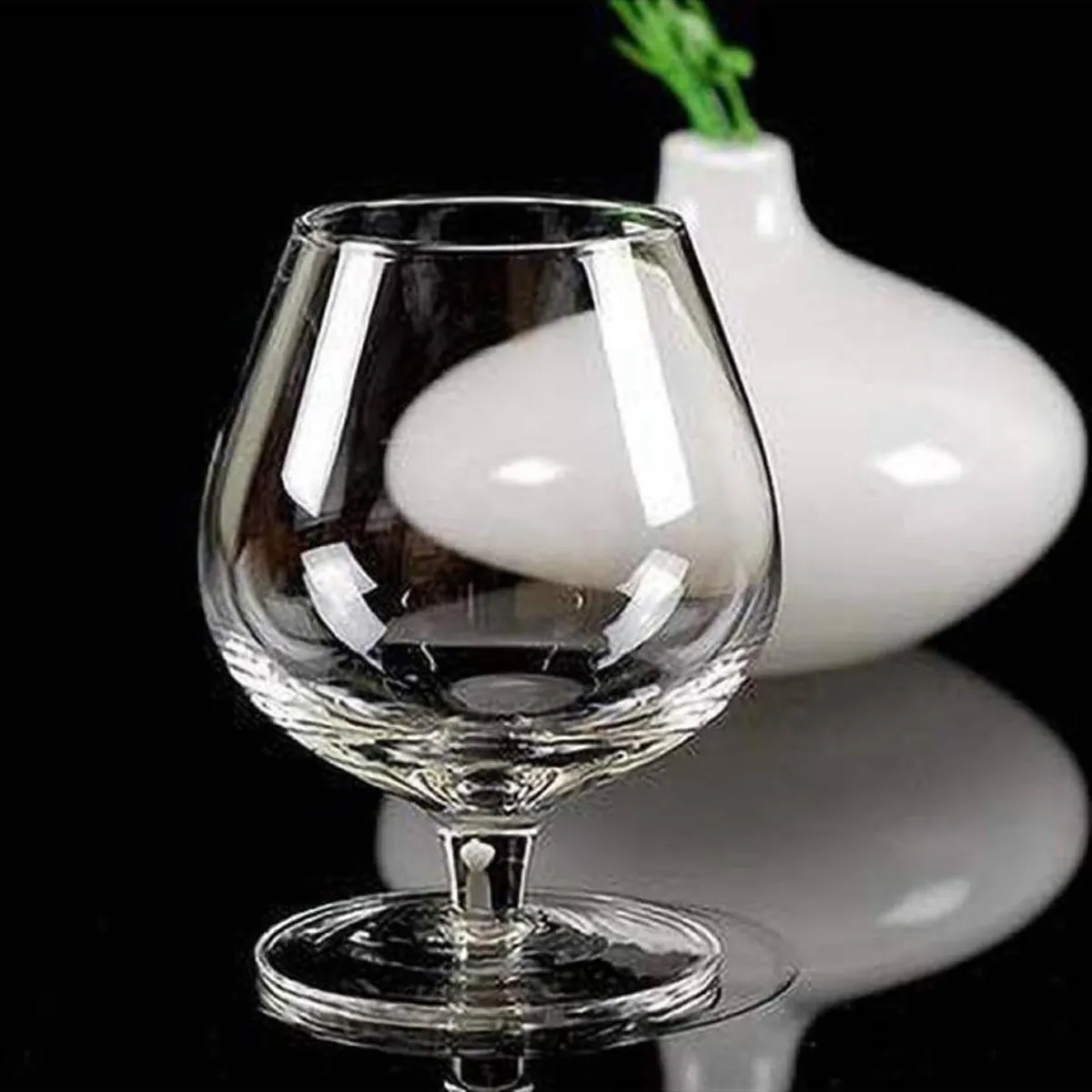 Clear snifter-style glass with a rounded bowl and short stem