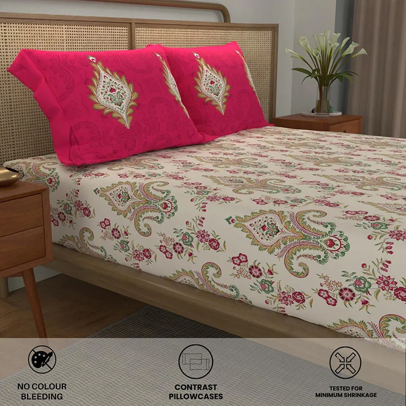 Angled view of ethnic motif bedsheet with contrasting pink pillow covers