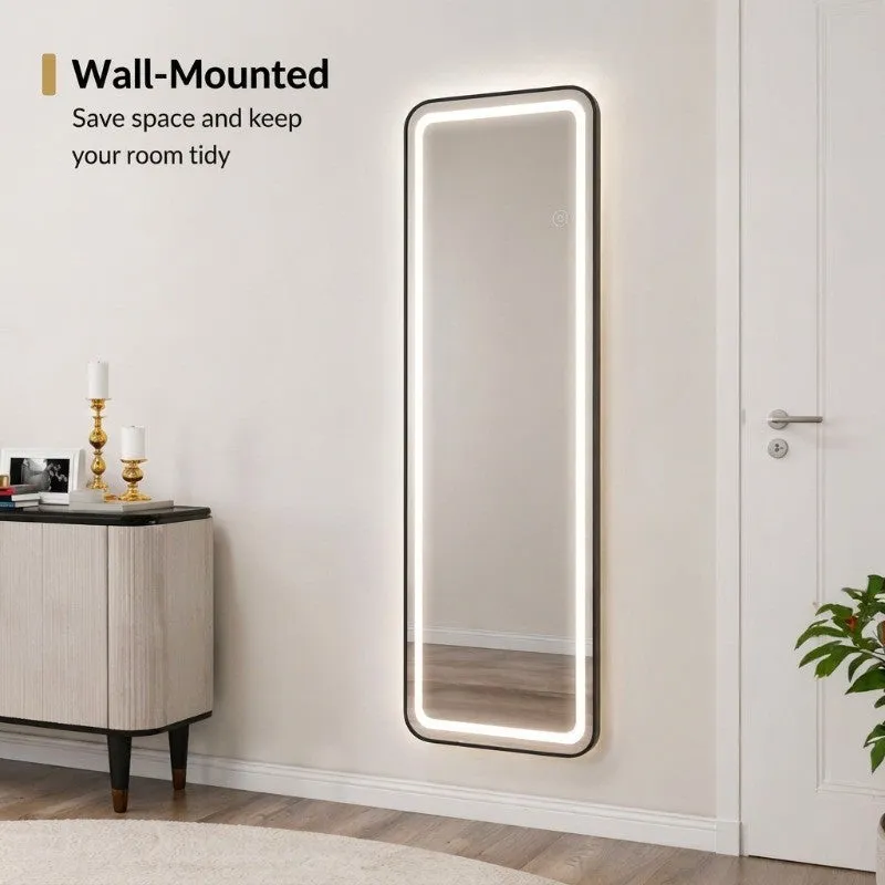 Full-length LED mirror shown standing beside a bedroom side table.