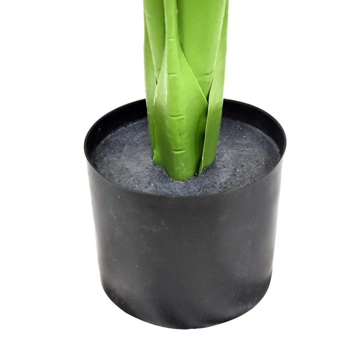 Close-up of the artificial plant's green stems in a black plastic pot