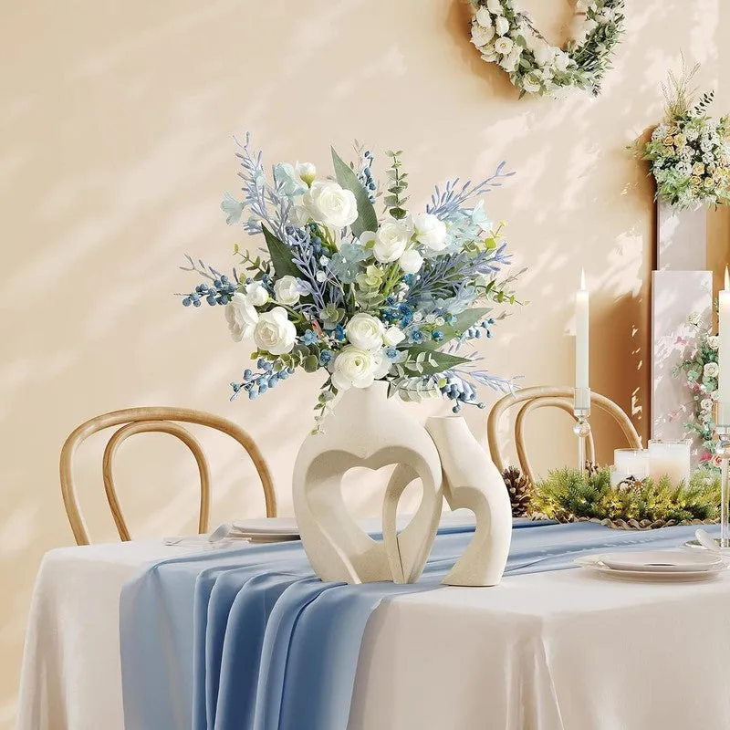 White sculptural vase set styled as a table centrepiece with flowers
