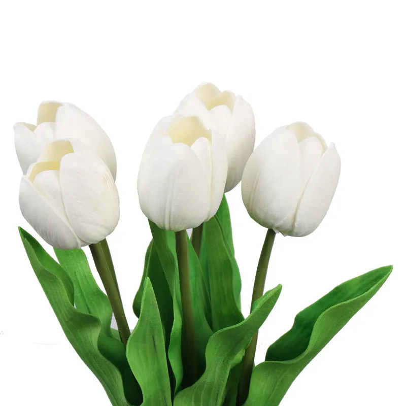 Close-up of white artificial tulip blooms and green leaves