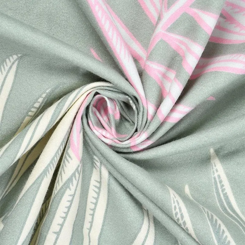 Close-up of green fabric with pink and white leaf print