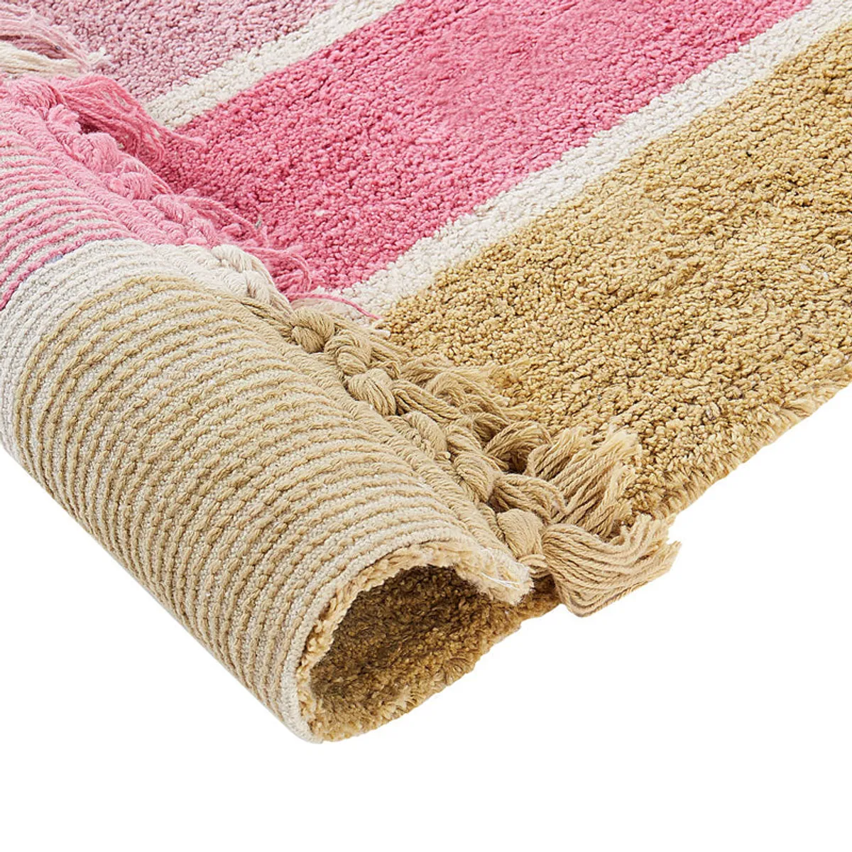 Rolled rainbow rug showing its plush tufted texture and fringed edge