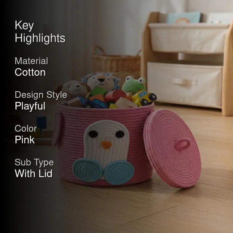 Pink penguin storage basket with lid beside nursery furniture