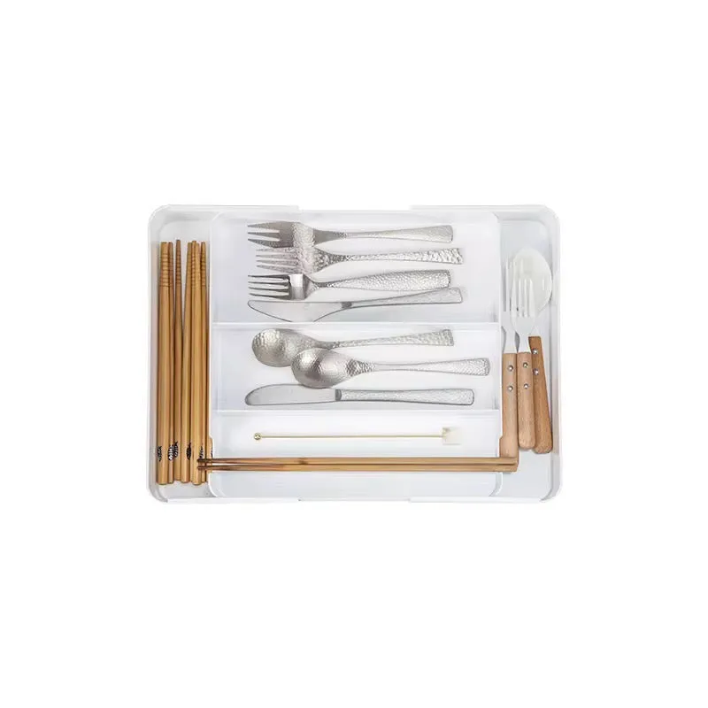 Top view of a white cutlery tray with cutlery arranged in compartments