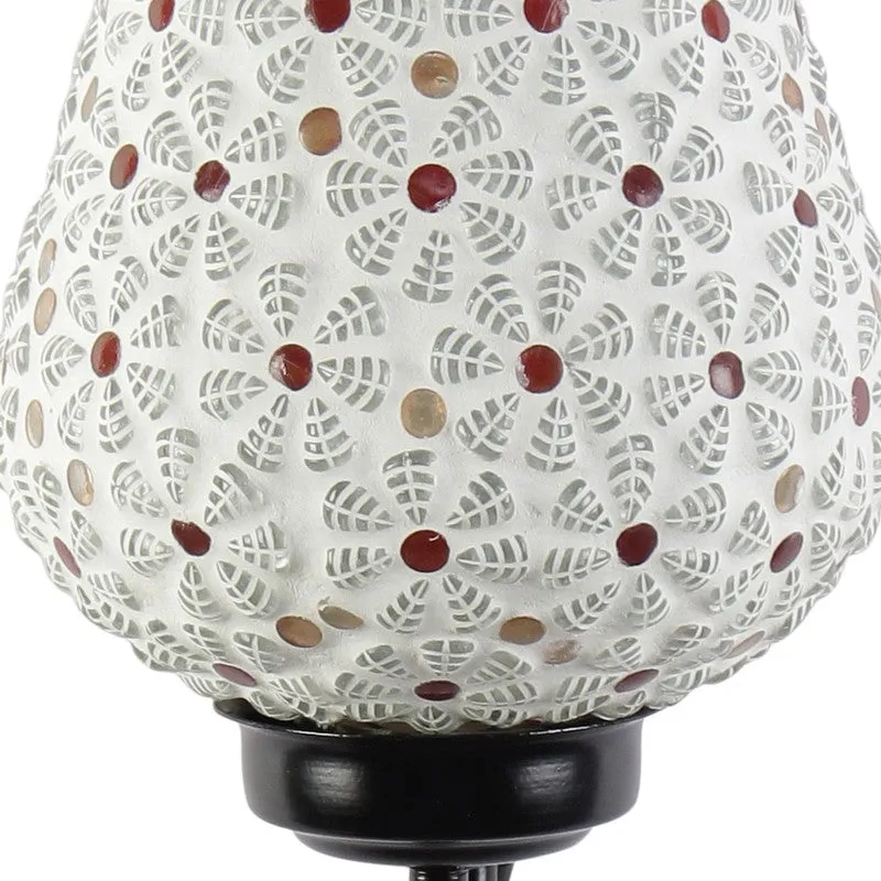 Close-up of white mosaic glass shade with red and gold accents