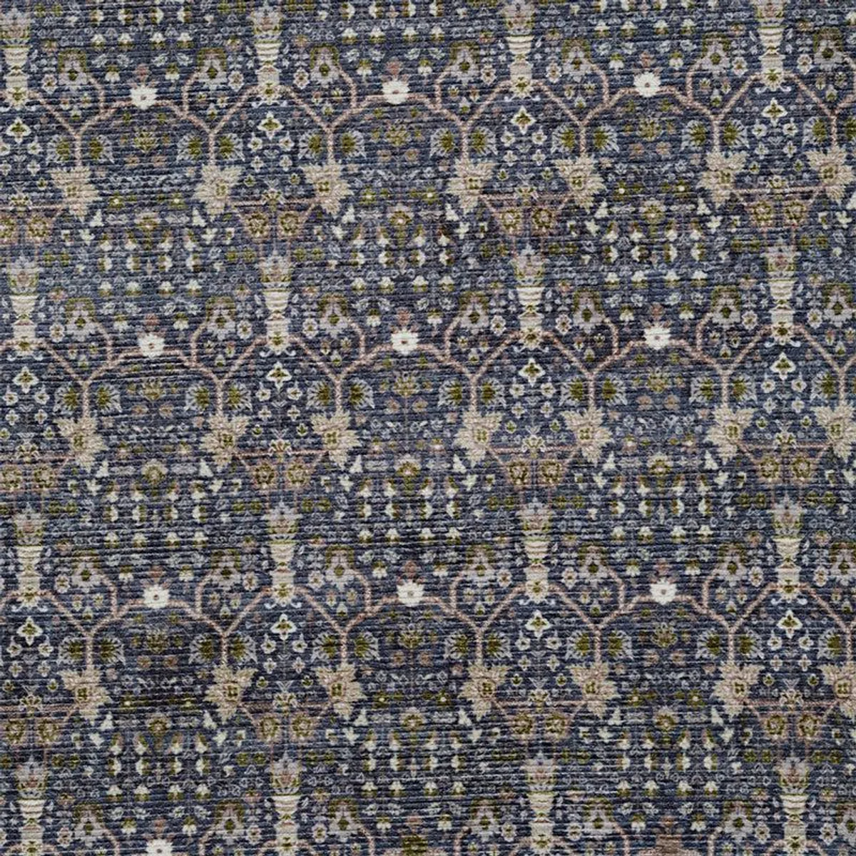 Close-up view of the carpet's repeating blue, green and beige motif