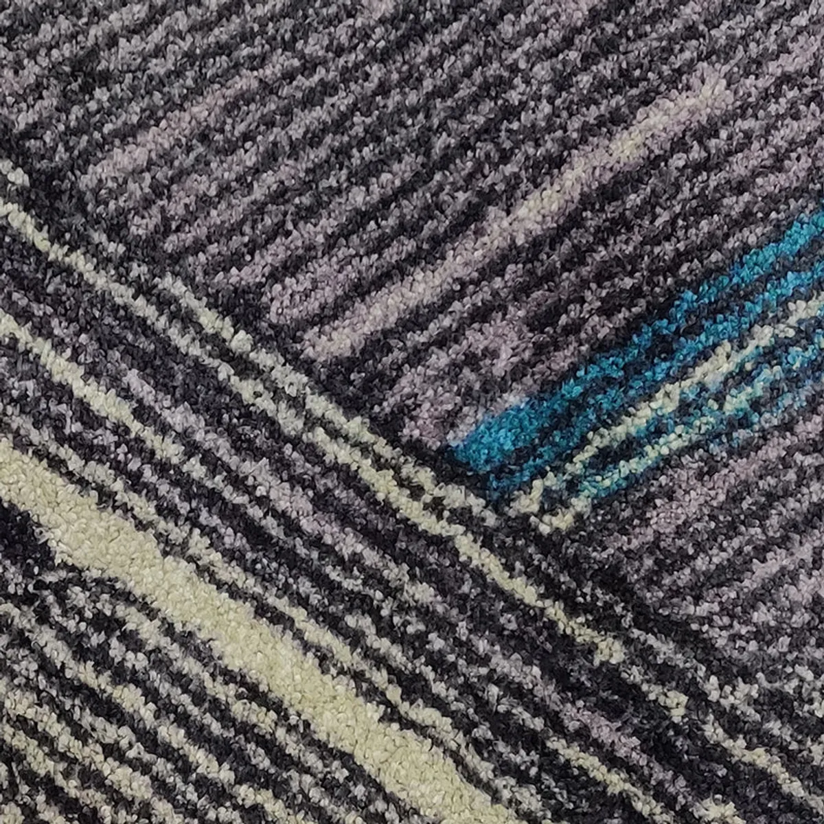 Close-up of the rug's textured geometric pattern in grey, black and blue