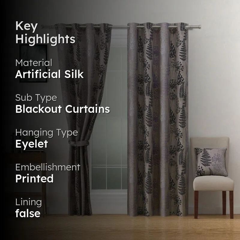 Brown printed curtains styled across a window with a chair and side table