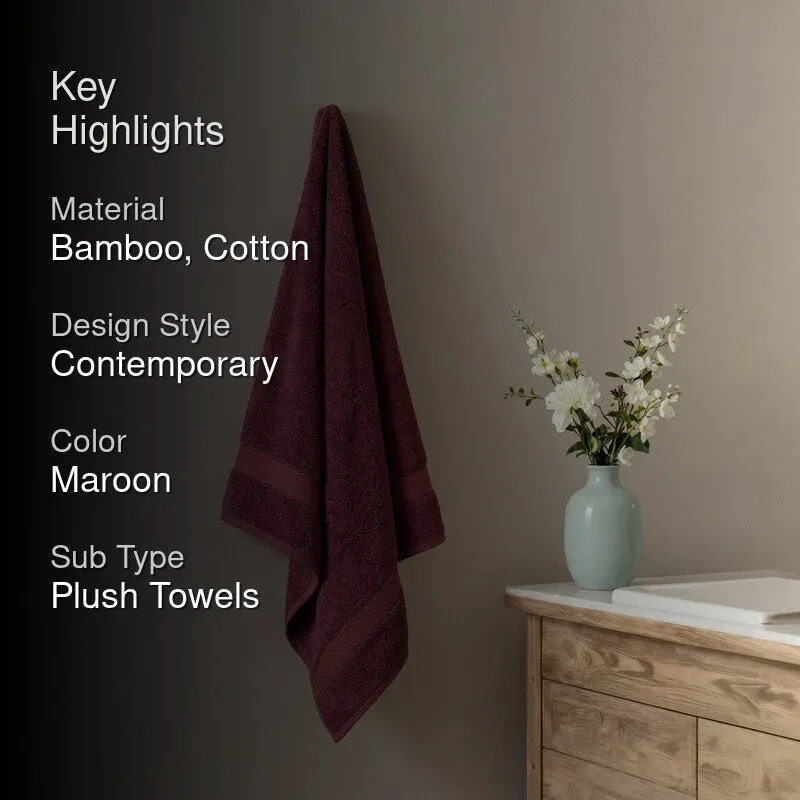 Maroon bath towel hanging on a wall with key highlights text overlay
