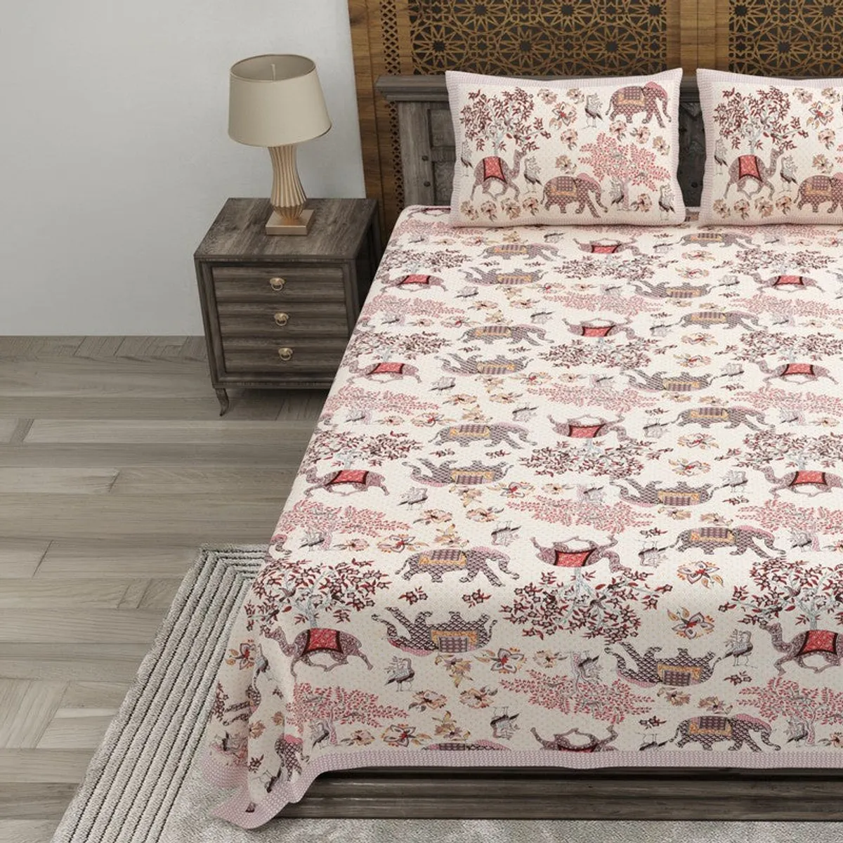Flat bedsheet with elephants, birds and floral motifs on a bed