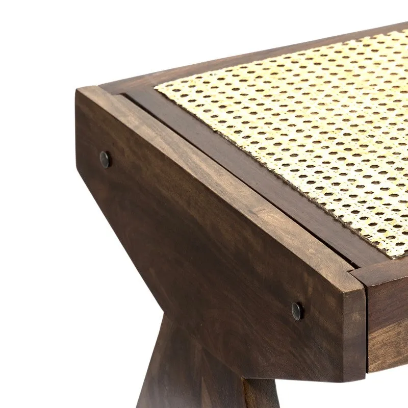 Corner detail of wooden bench with woven cane seat