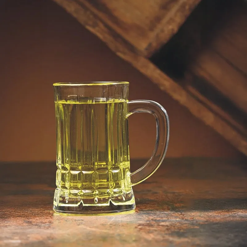 Clear ribbed beer mug filled with a golden drink against a warm wooden backdrop.