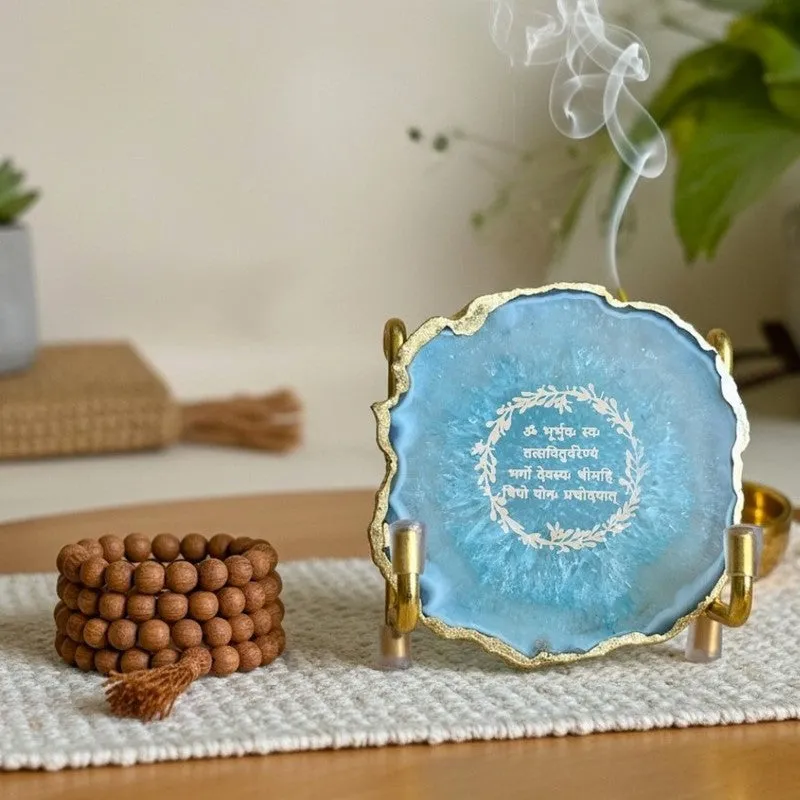 Turquoise agate mantra accent displayed on a tabletop with prayer beads nearby