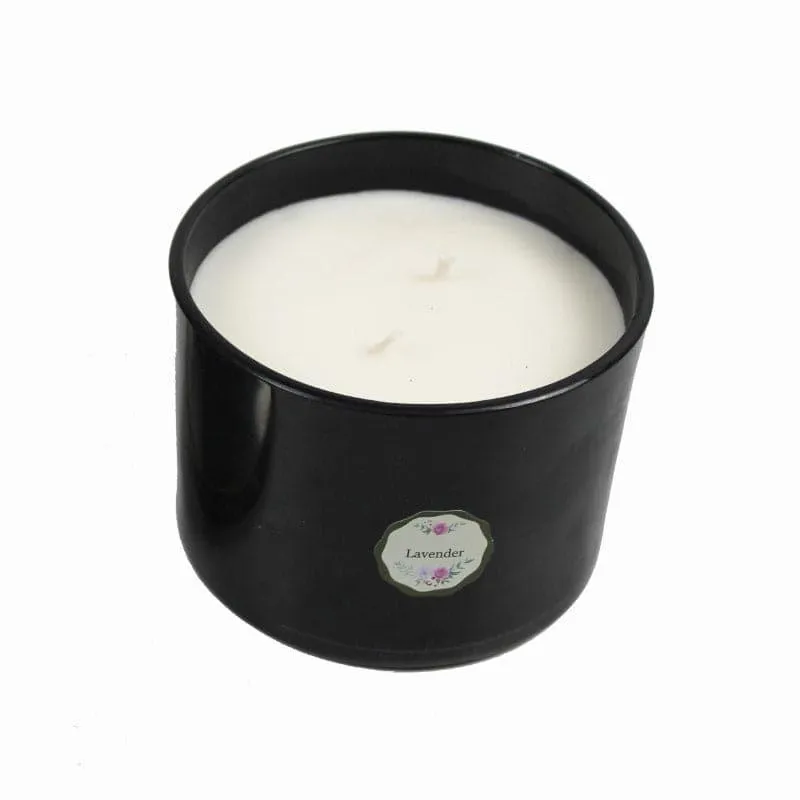 Black candle jar with white wax on a plain white background