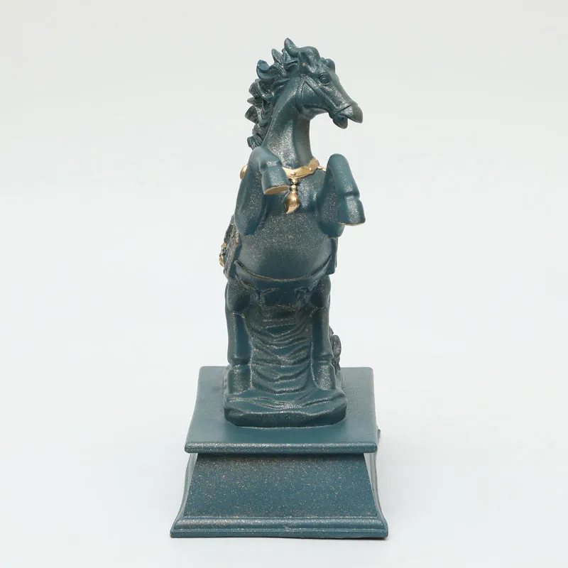 Side view of a grey horse showpiece with raised front legs and gold detailing