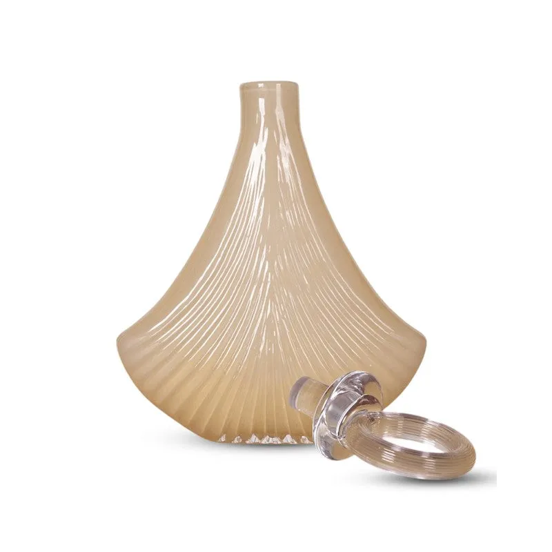 Ivory glass vase with detached clear ring stopper on white background