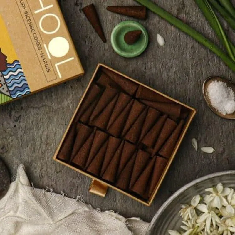 Close-up of brown incense cones arranged inside an open box
