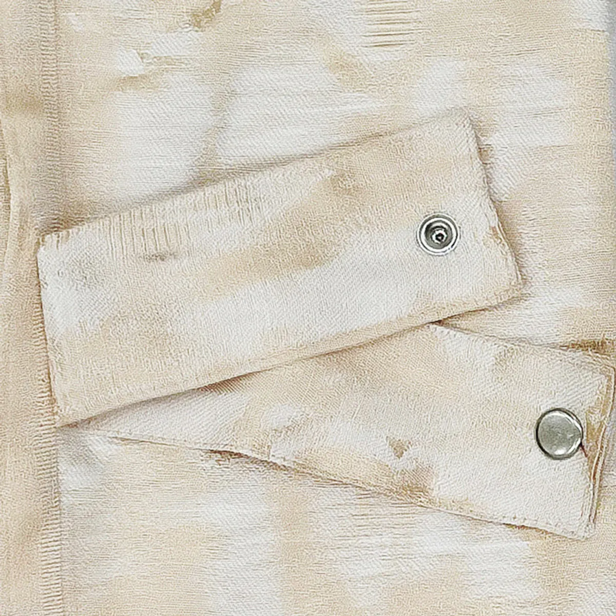 Close-up of the beige textured curtain fabric with abstract jacquard detailing