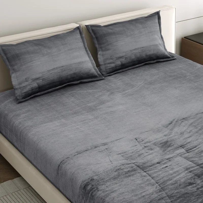 Angled close-up of matching pillow covers and bedsheet on the bed