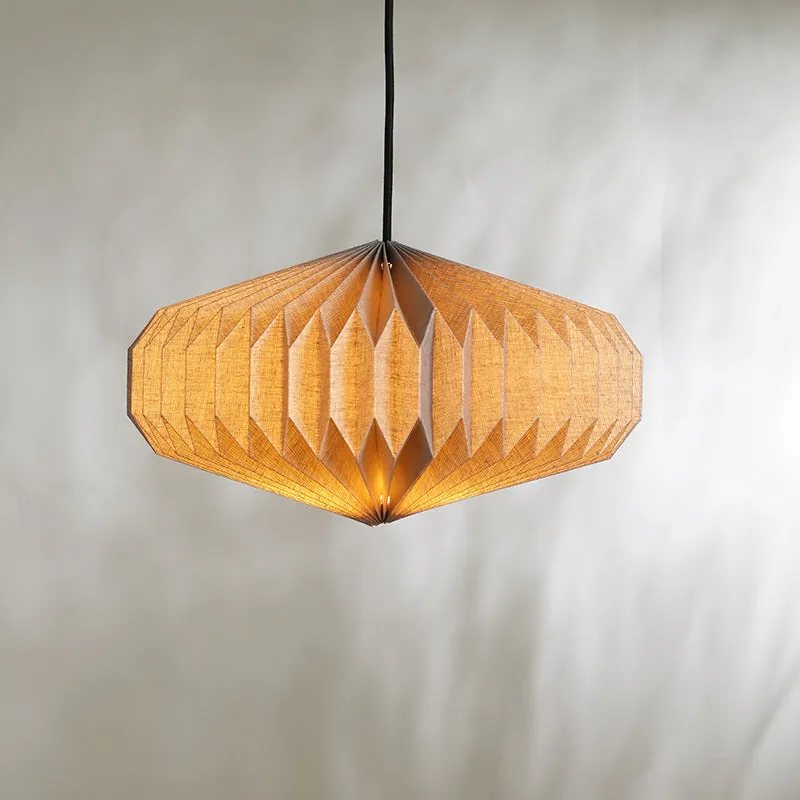 Lit oblong paper ceiling lamp with pleated grey shade against a plain wall