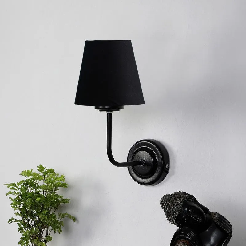Black wall-mounted lamp with cone shade and round backplate