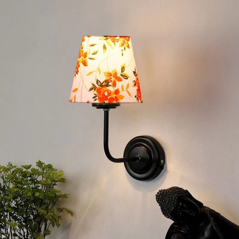 Wall lamp with white and orange floral shade on black round base