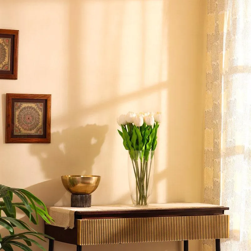 White artificial tulips displayed in a vase in a bright interior