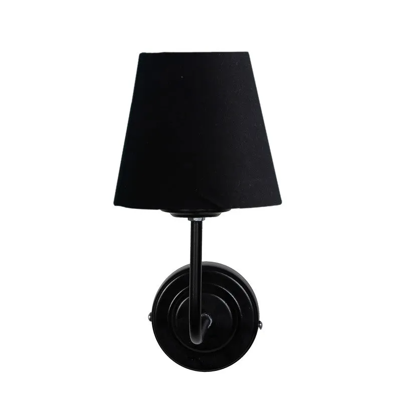 Front-facing black wall lamp with tapered shade on white background