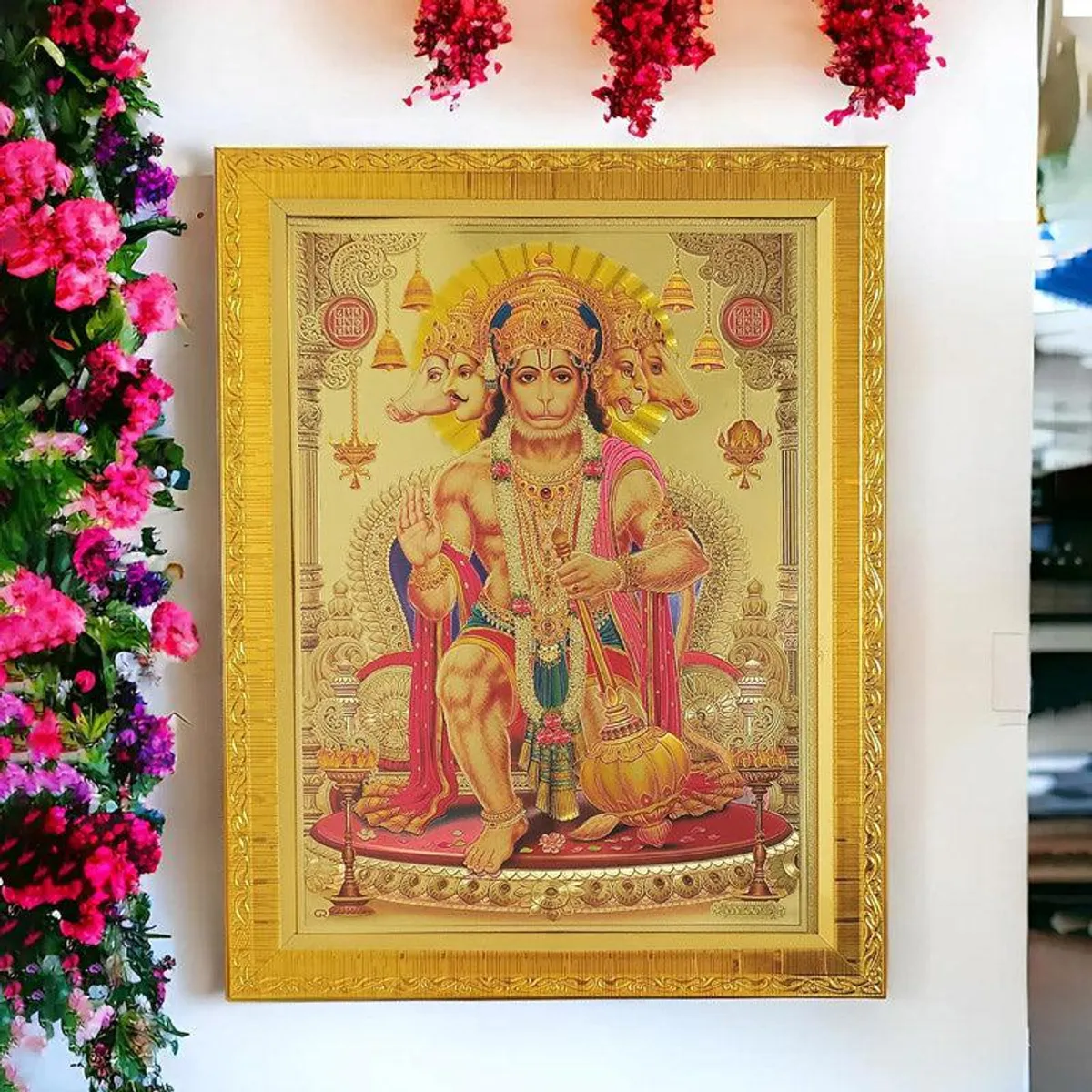 Close view of Hanuman devotional image in a gold rectangular frame