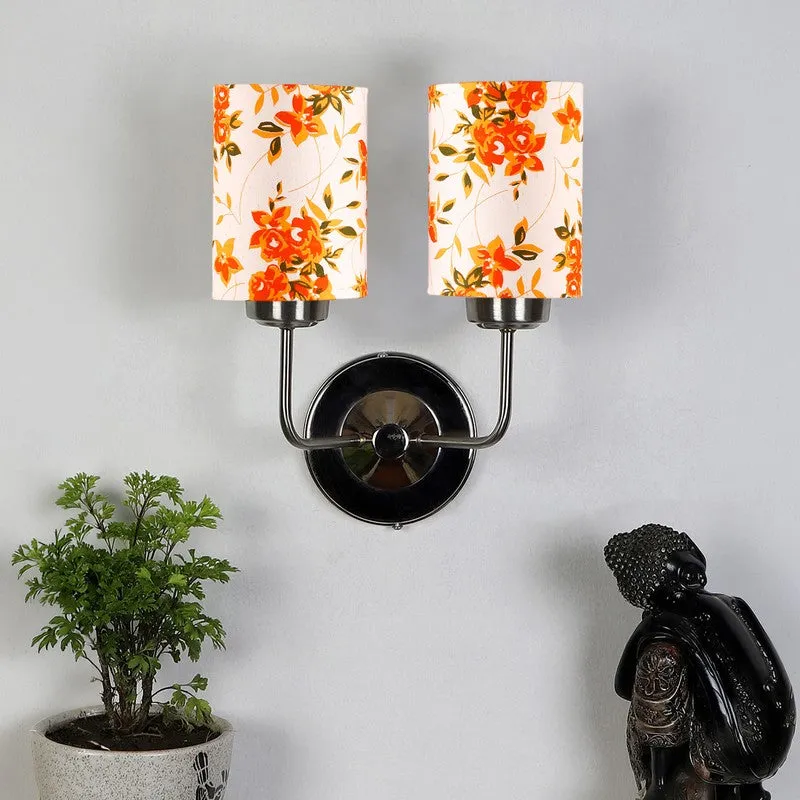 Front view of dual floral shade wall lamp with steel base
