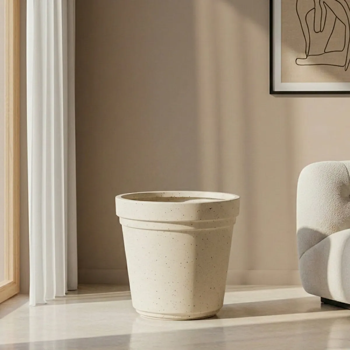 Empty off-white speckled planter with a cylindrical tapered shape
