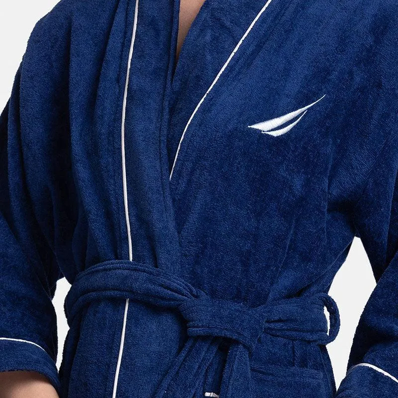 Close-up of navy blue robe fabric, white piping and tie belt