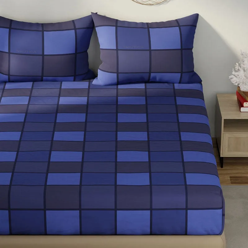 Close view of the blue geometric bedsheet and matching pillows