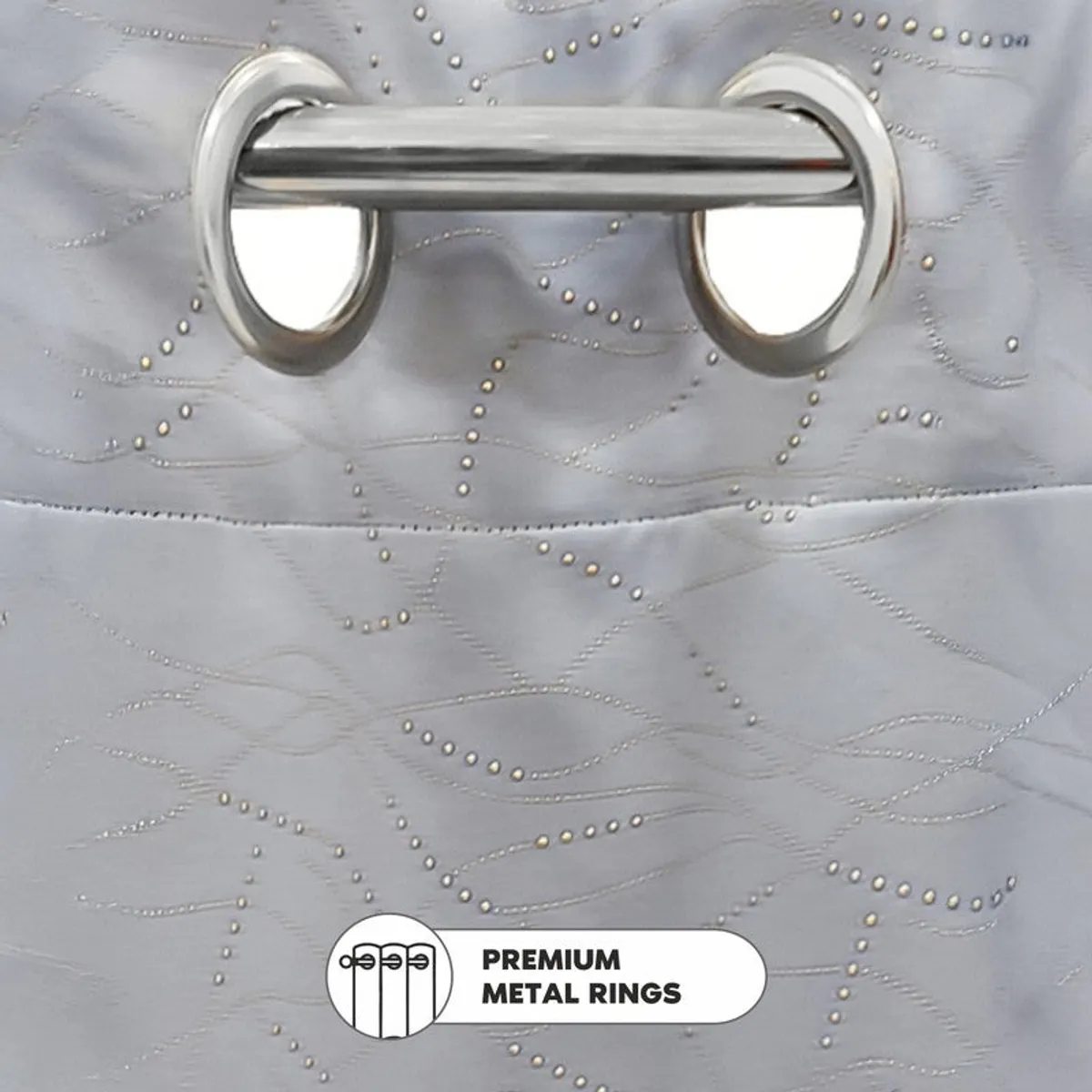 Close-up of curtain eyelets and stitched grey fabric with gold accents