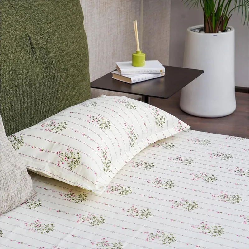 Close-up of off-white bedsheet and pillow cover with floral striped print