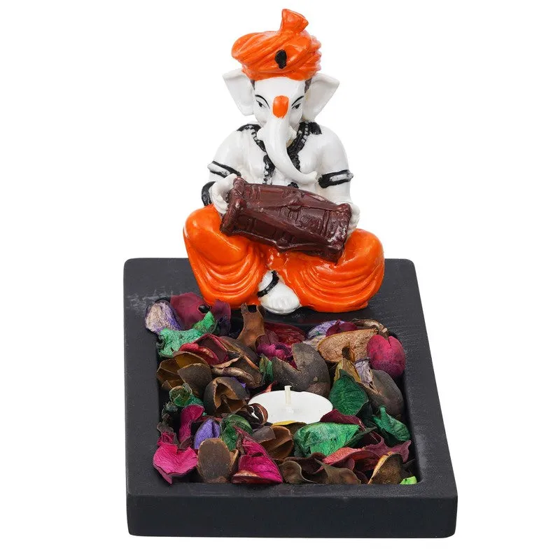 Front view of Ganesha figurine tea light holder on black base