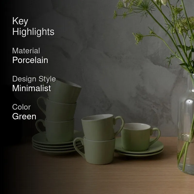 Green cup and saucer set displayed with a minimalist dining arrangement
