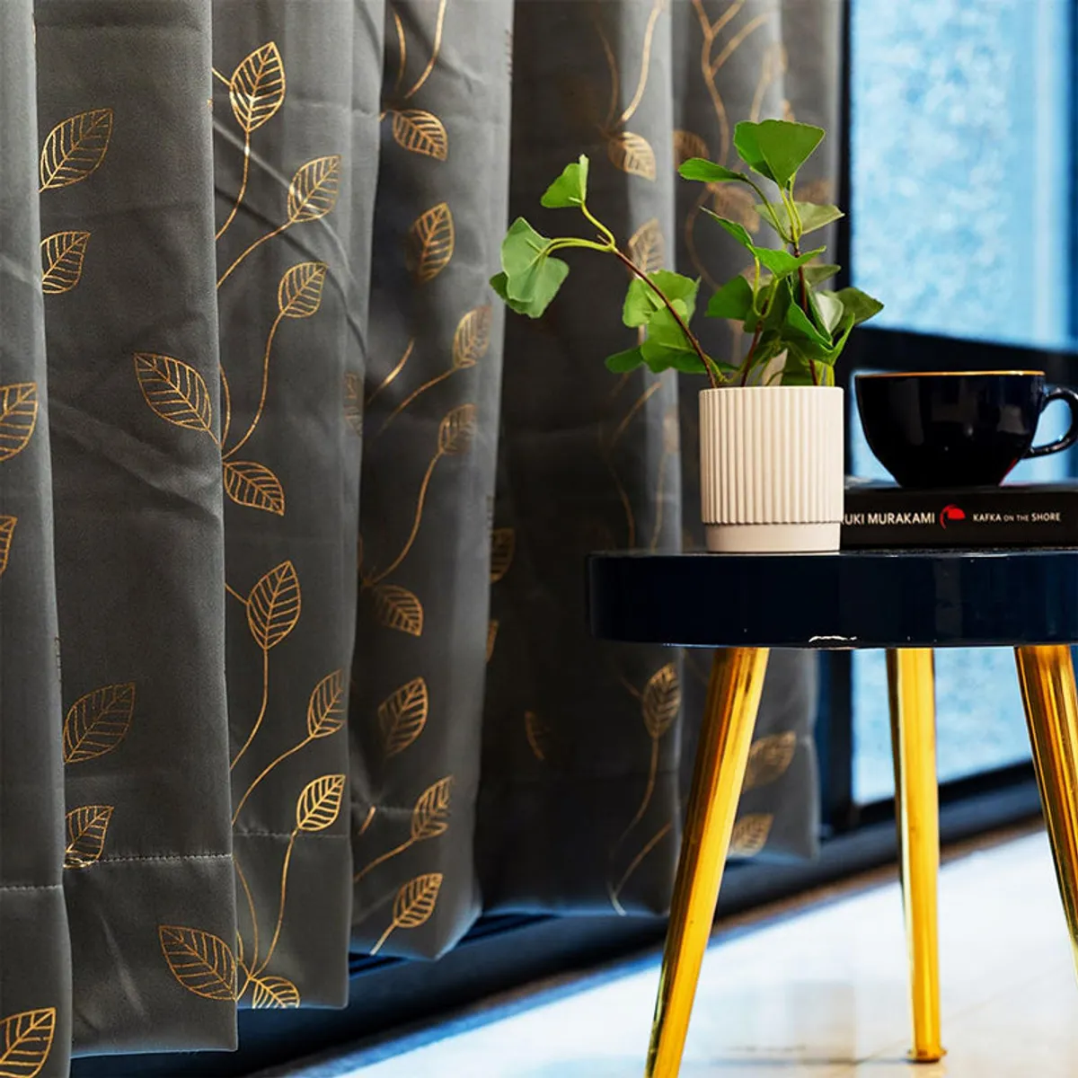 Close-up of charcoal curtain fabric with repeating gold leaf motifs