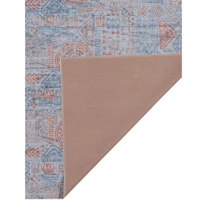 Corner of carpet showing plain underside and patterned top