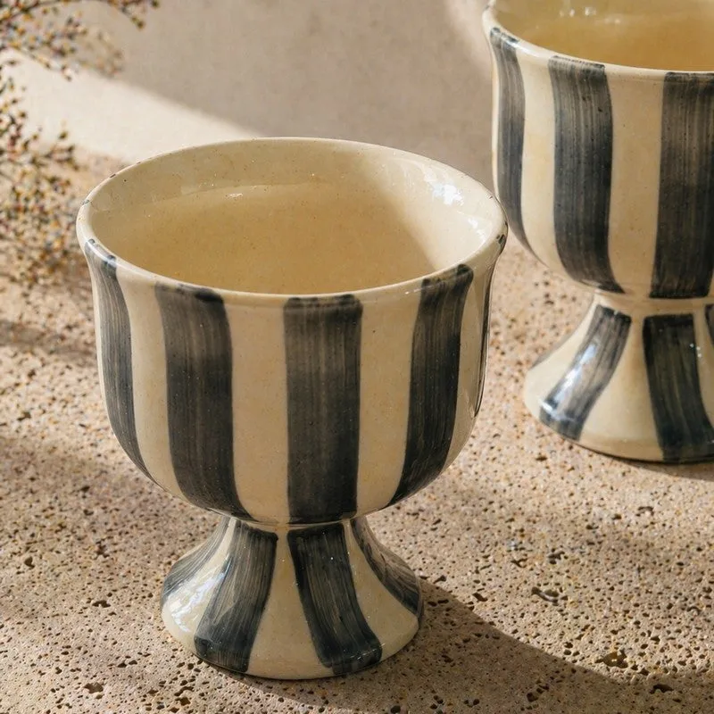 Close-up of a striped ceramic pedestal ice cream cup with glossy finish