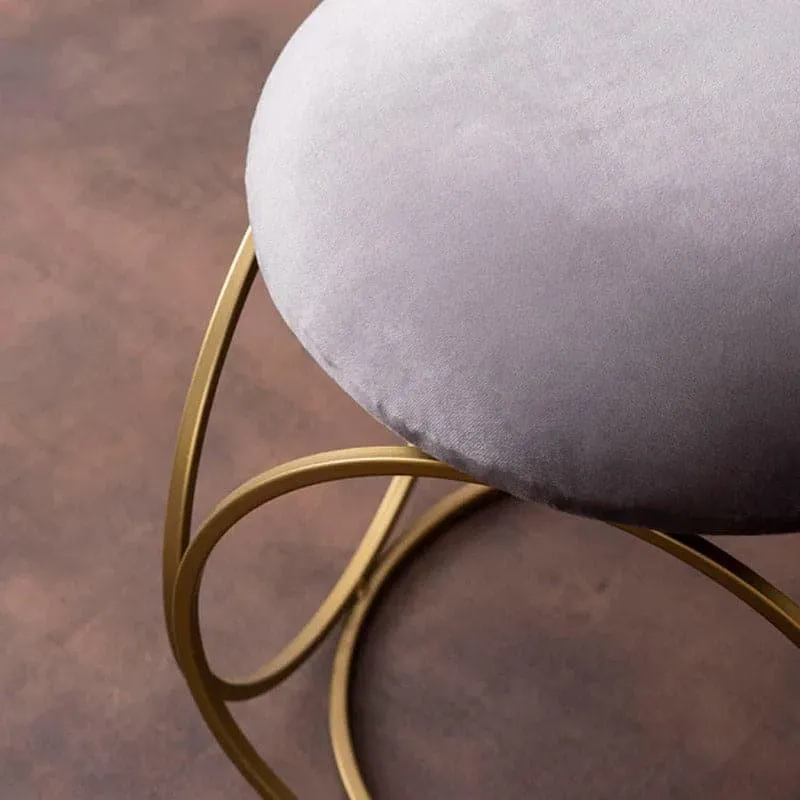 Close-up of grey velvet seat and circular gold metal frame