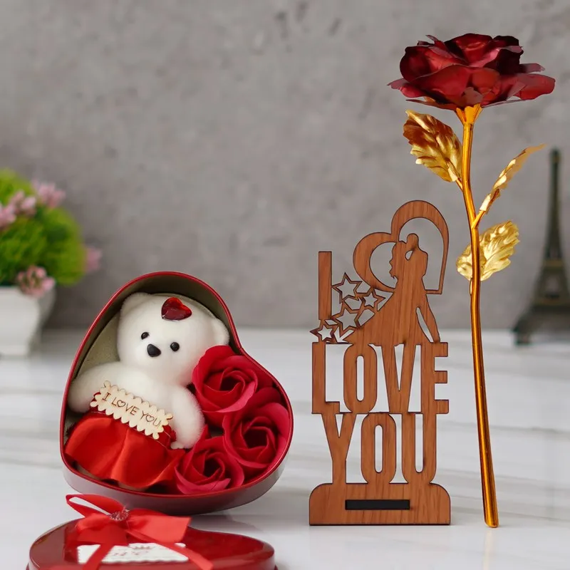 Open heart-shaped red gift box with teddy, roses, wooden decor and rose stem