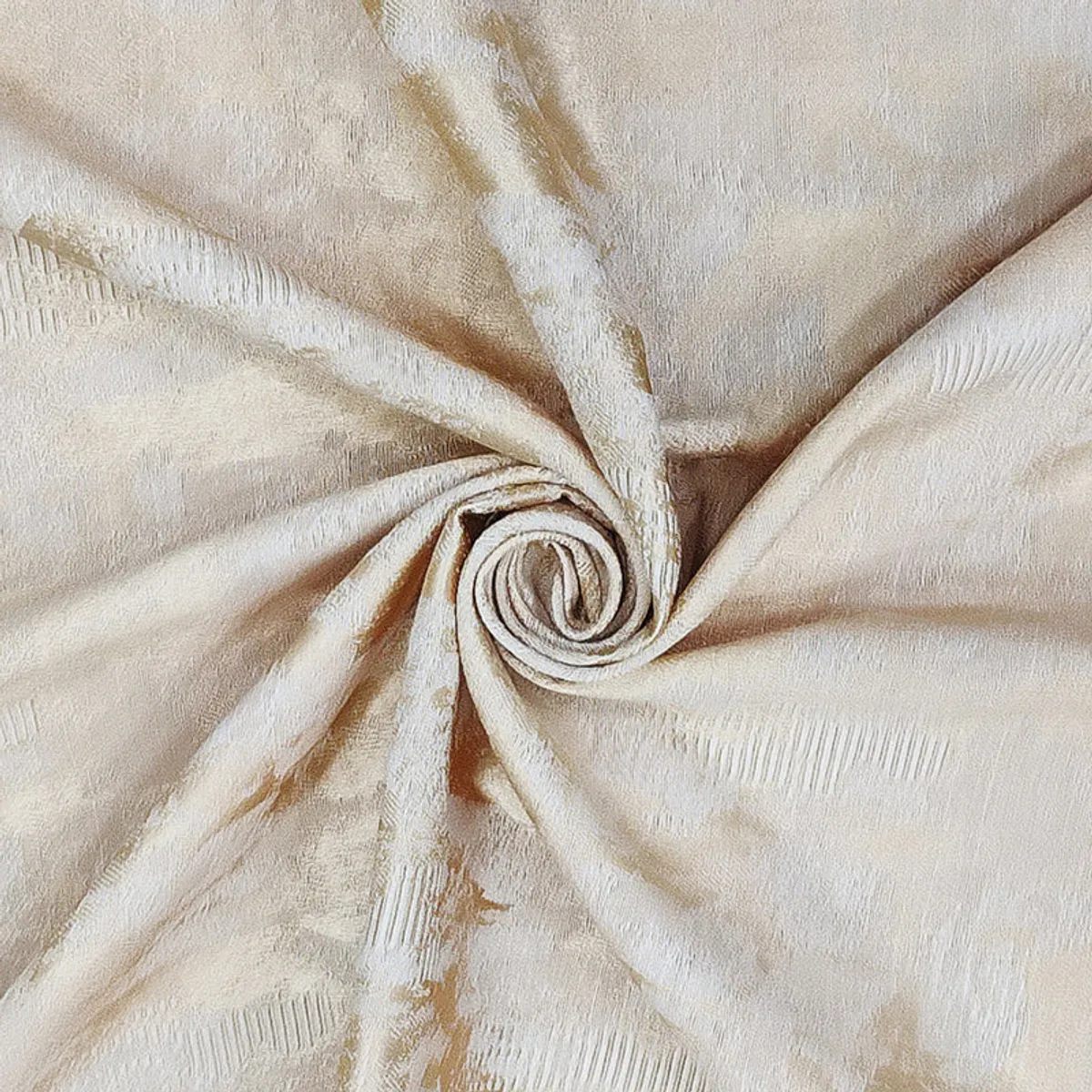 Soft beige curtain fabric gathered to show its texture and drape